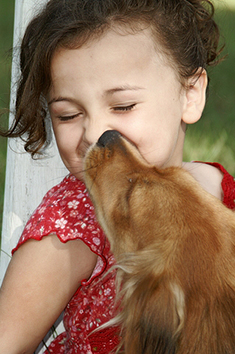 dog kissing girls face