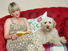 Lady sitting with dog on couch