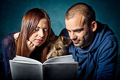 Man and Woman reading a dog breed book